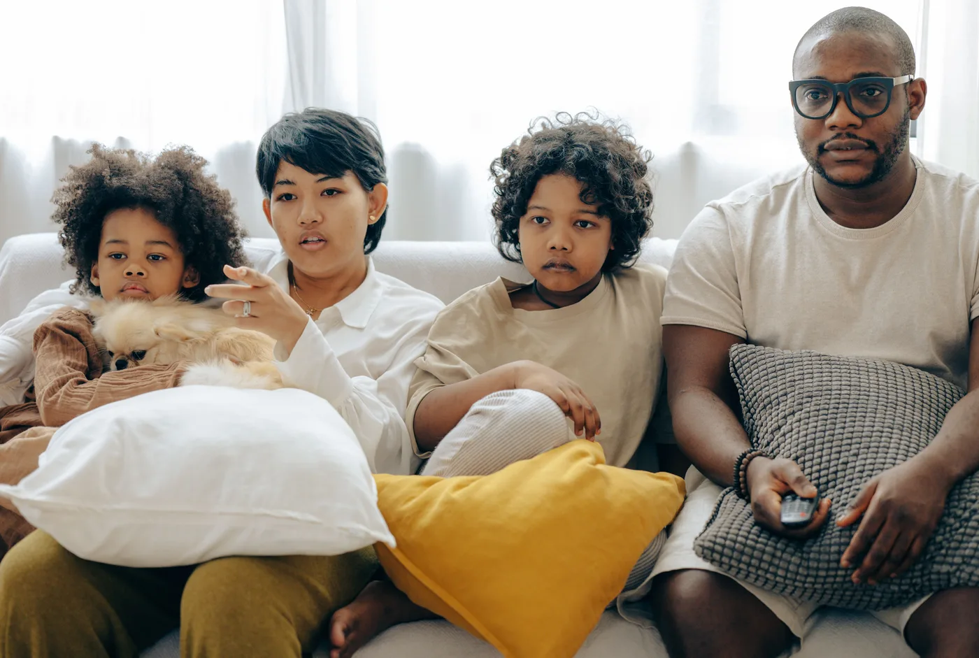 Family relaxing together on a sofa at home